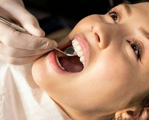 Girl getting a routine dental checkup.